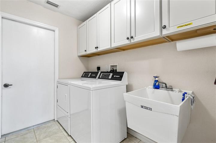 Laundry Room and door leading into the garage.