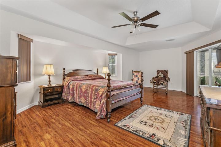 Master Bedroom with partial view of sliding glass doors leading into the lani/pool area