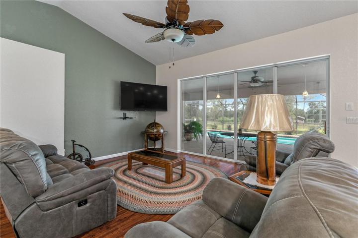 Living area with view of pool and back yard.
