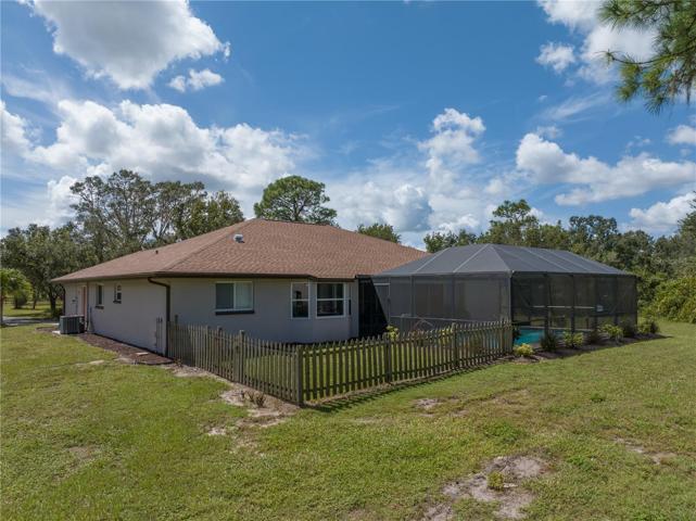 Back of home with fenced area for pets.