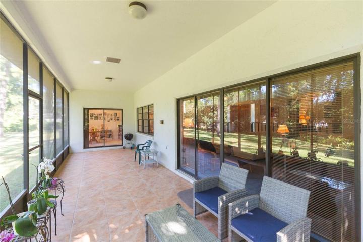 Screened in lanai with eat in kitchen in the background