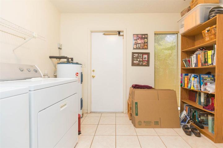 Inside laundry leading to garage with extra closet