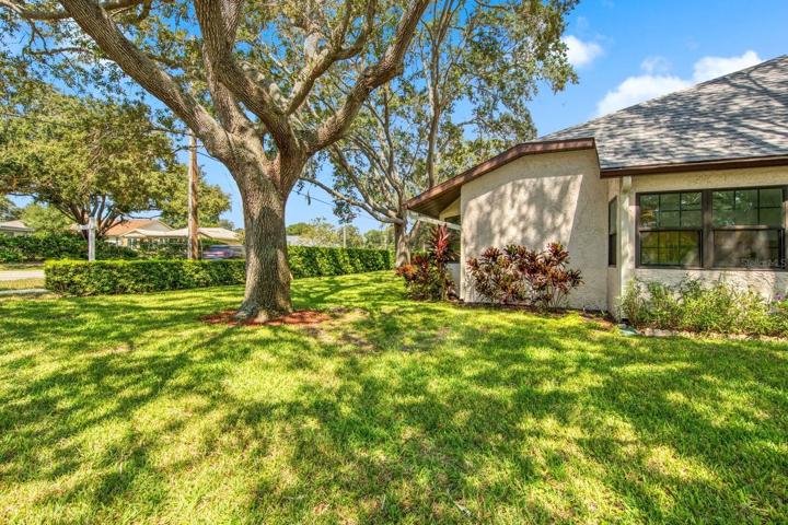 End unit villa with larger side yard~