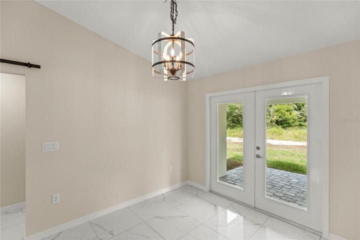 DINING AREA WITH FRENCH DOORS LEADING TO THE LANAI