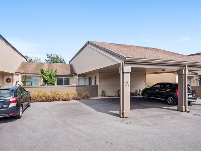 Front of home with 2 parking spots - one is covered