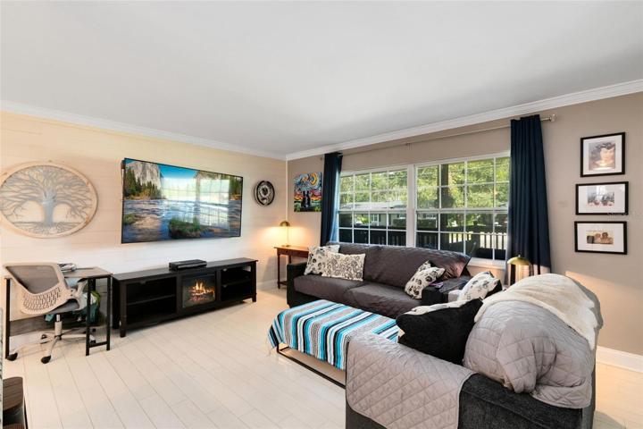 A shiplap accent wall adds a warm and welcoming touch to the family room.