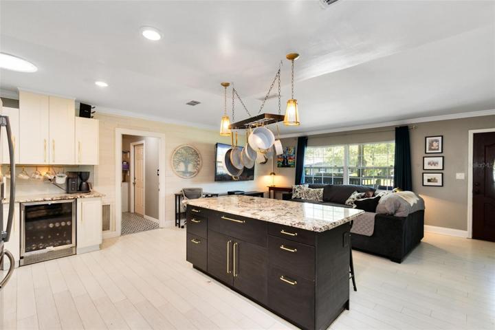 Stainless steel appliances, including a gas stove and wine fridge, cater to the needs of any aspiring chef.