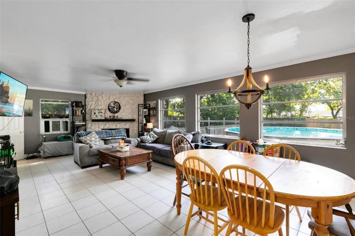 Venture from the kitchen to the living room and dining room combination, where a stone front wood-burning fireplace takes center stage, creating a cozy atmosphere.