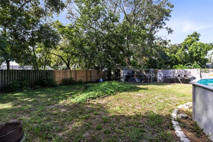 The fully fenced backyard provides ample space to enjoy the outdoors, and you'll even find a banana tree and grape vines for delicious homegrown treats.
