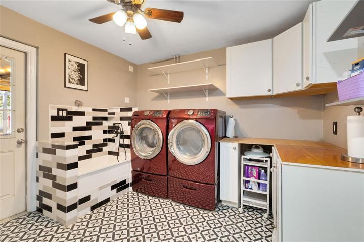 Adjacent to the kitchen, you'll discover a spacious laundry room with fresh new floors and additional storage space. Your furry family members will appreciate their very own pampering station, complete with a convenient dog bath.