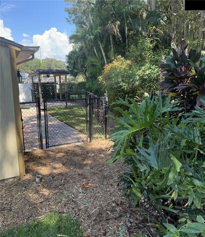 Back yard fully fenced w/privacy hedges