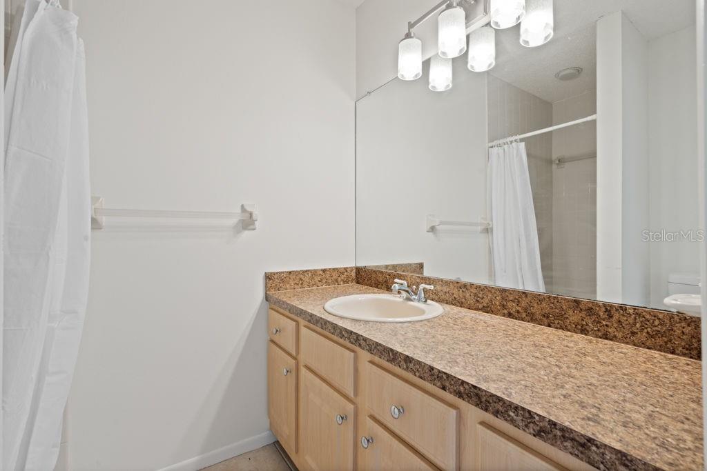 Primary bathroom with shower and new light fixture