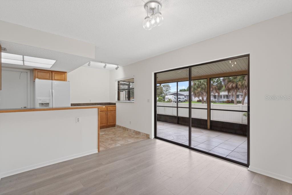 The kitchen has an eat-in area and a screened in porch on the back.