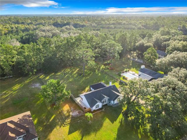 1.02 Acres home backs up to woodlands.