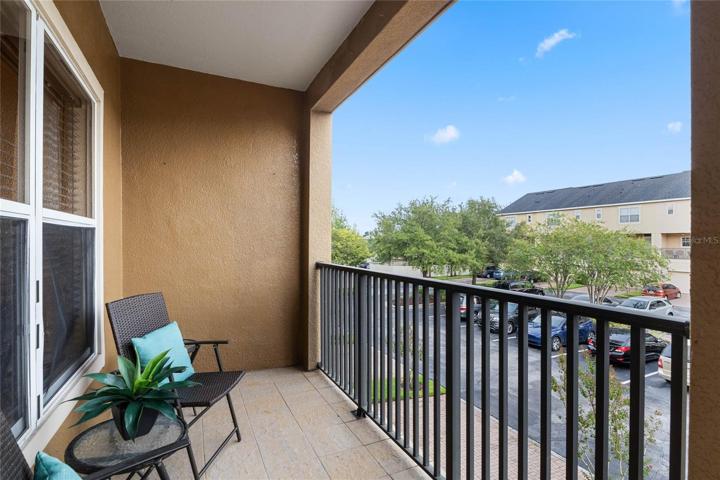 Long covered balcony looks out over the rear of the property