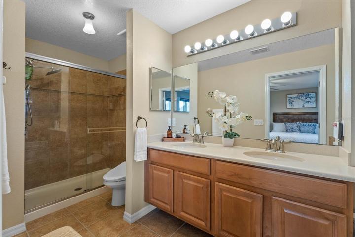 Master bath with large walk-in shower, vanity w/ dual sinks & cabinet storage