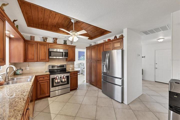 kitchen showing entry door to far right rear and partial dining/living area middle rear