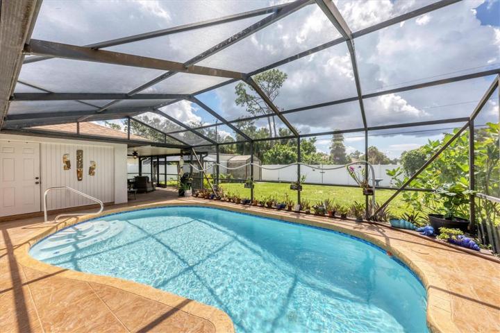 door at left rear is bedroom 3 and lanai beyond - gorgeous yard, take note!