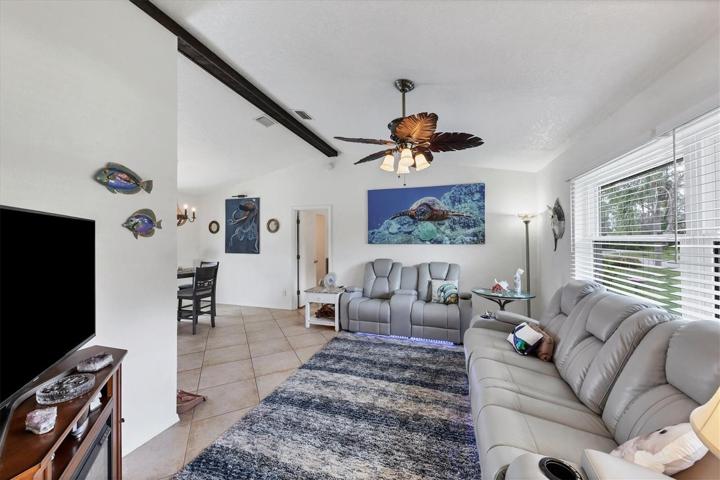 another view of living room and partial dining  (door to rear is primary bedroom)