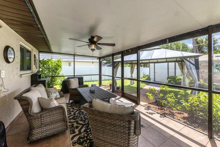 spacious lanai with insulated roof and gazebo beyond which seller likes to use for grill and meat smoker area