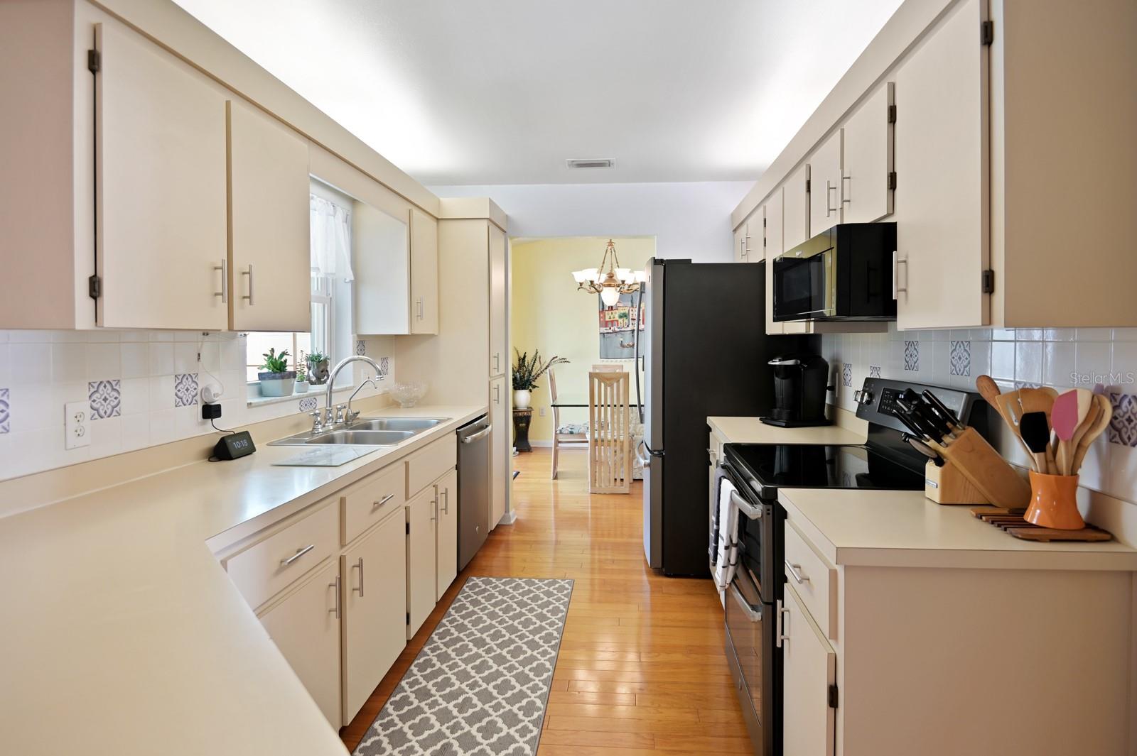 Cute tile backsplash and views of the pool makes this an enjoyable space for cooking.