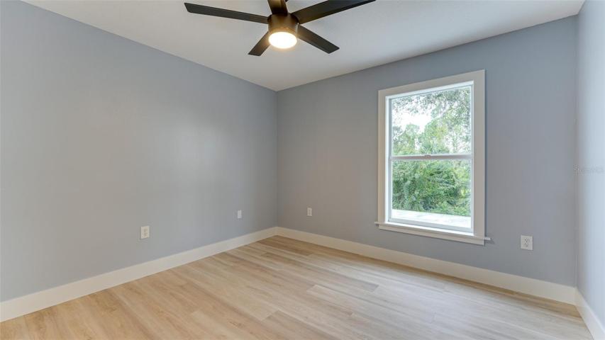 Third bedroom with beautiful green views of back yard