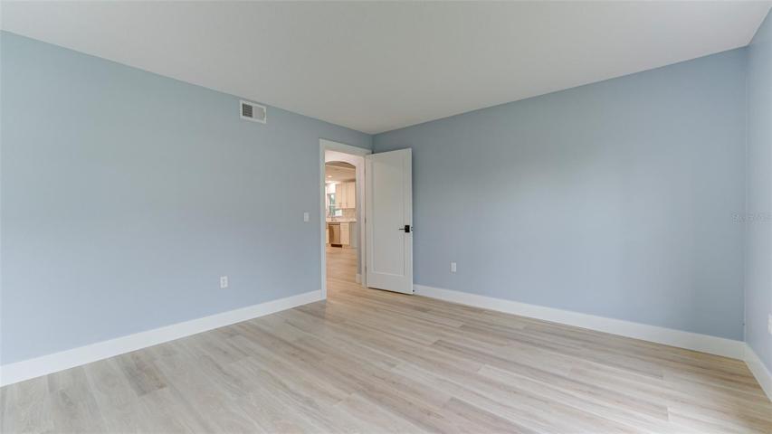 Main level Bonus Room can be used as bedroom or office and can be closed off for privacy