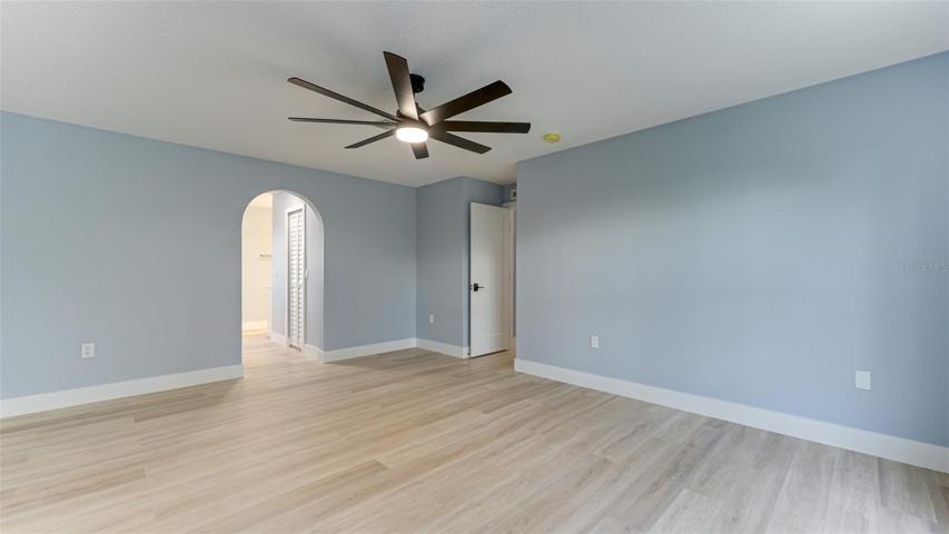 Primary bedroom with hallway to closets and en-suite bath