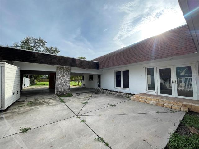 Front of home. The main entry to the right or pull under the carport for covered parking and kitchen door access