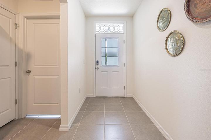 Foyer with custom front door and transom.