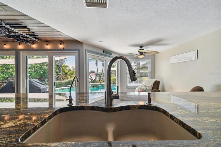 Kitchen Island w/Bar Sink Looking to Backyard Pool & Water Views