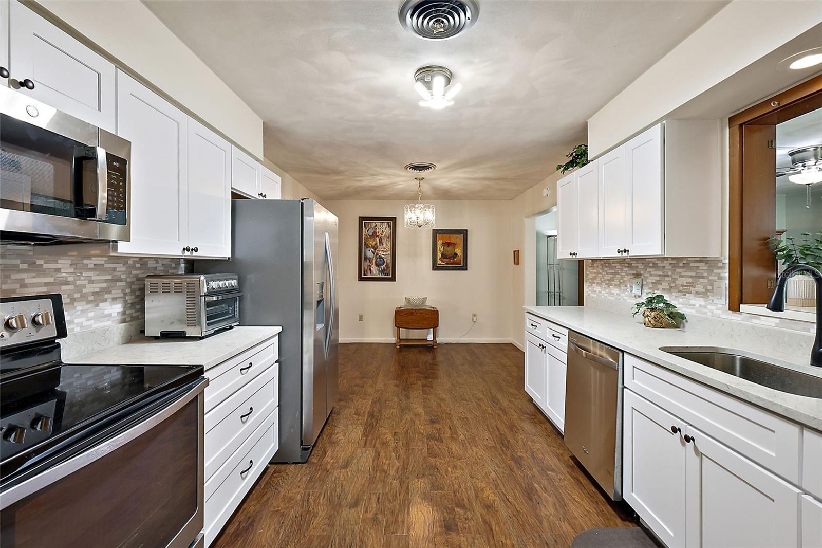 Beautifully updated kitchen with quartz countertops and shaker style cabinets