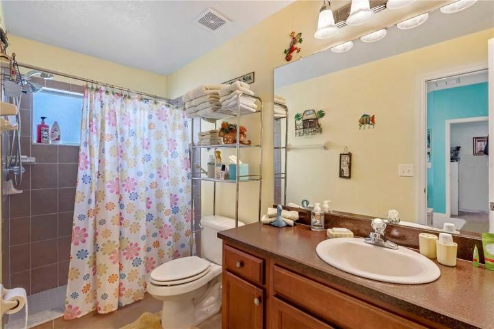 Bathroom two has tile step-in shower, tile flooring, and updated fixtures.