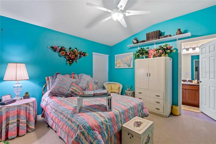 Bedroom two has ceiling fan, carpet, and built-in closet.
