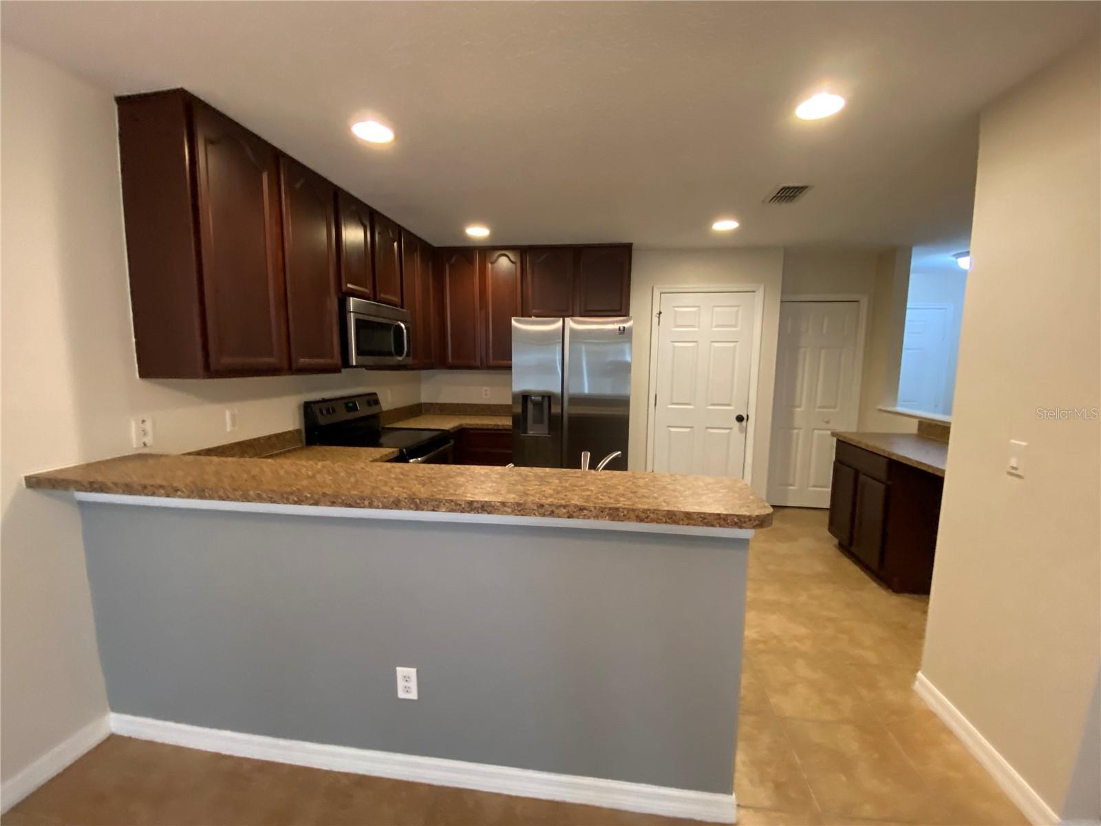 Kitchen with Breakfast Bar and Desk Area