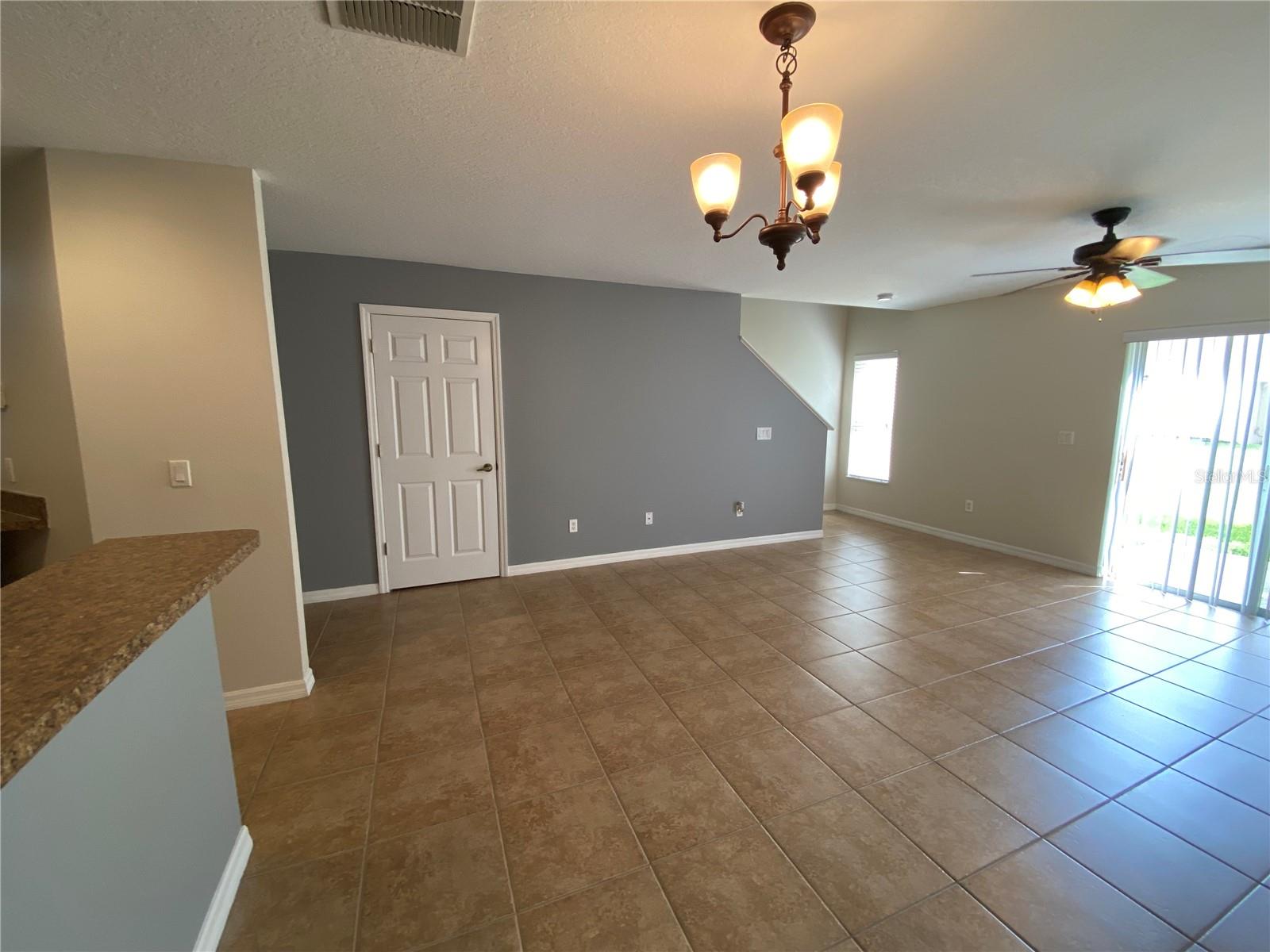 Living and Dining Areas with Door to 1\2 Bathroom