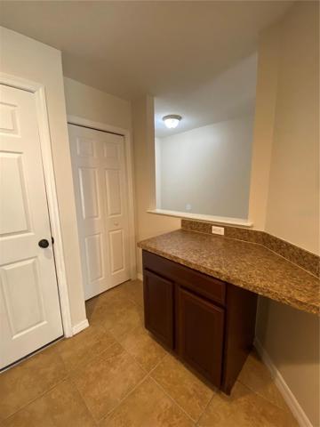 Door Leading to Garage, Pantry Door and Desk Area in Kitchen
