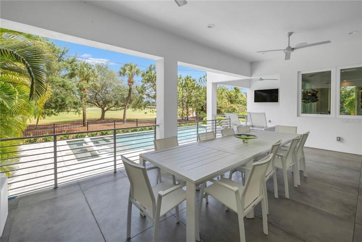 EATING SPACE AND MOUNTED TELEVISION TO ENJOY WHILE OUT ON THE COVERED LANAI