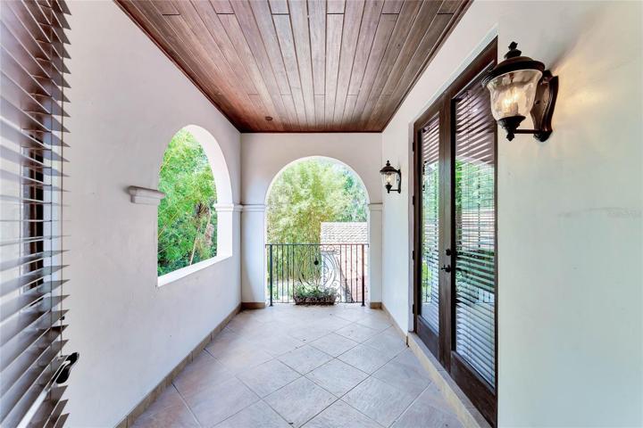 Upstairs balcony is shared by back two bedrooms and is a cozy spot take Florida Fall breezes in.