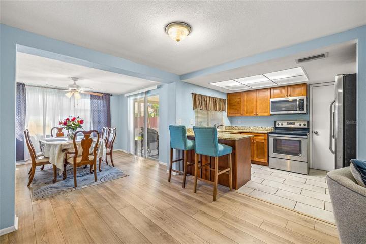 Updated kitchen with granite counter tops, wood cabinets, stainless steel appliances.  Eat right at the counter or the formal dining room.