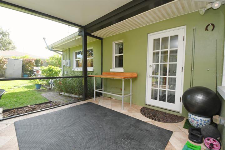 This area on the patio could be transformed into an outdoor kitchen or additional living space/3rd bedroom.
