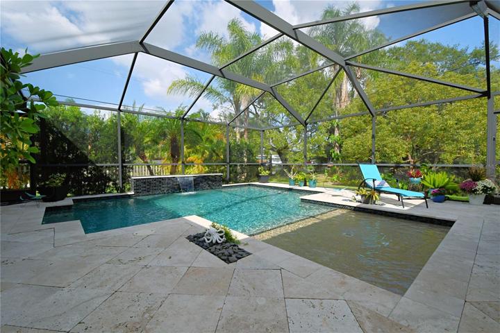 Built in 2017, the in-ground pool boasts a double tone Pebble Tec finish and is adorned with glass tiles.
