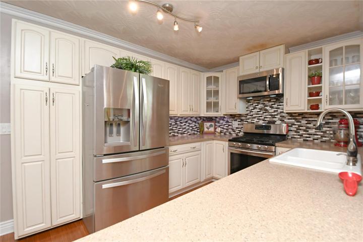 The kitchen comes with plenty of cabinet space for storage.