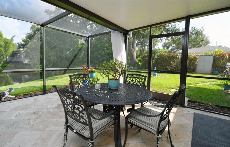 The pool and back patio are screened-in by a pool enclosure, ensuring a comfortable environment.