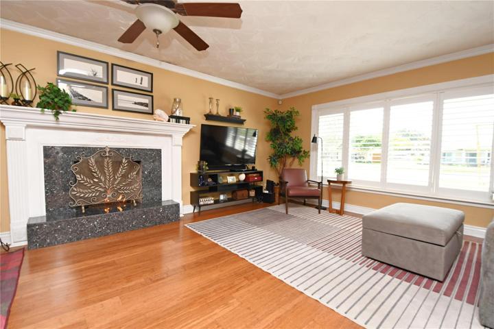 The gas fireplace with a marble base and mantle serves as a cozy focal point, perfect for gathering around on cool evenings