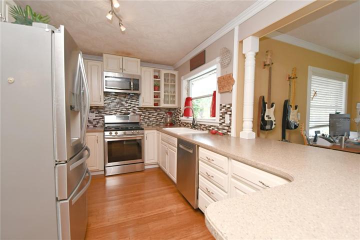 The kitchen features matching stainless steel appliances, including an extra quiet Bosch dishwasher.