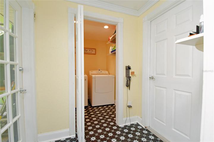 Remodeled laundry room with washer and dryer. This area offers an access to the garage and to the pool.