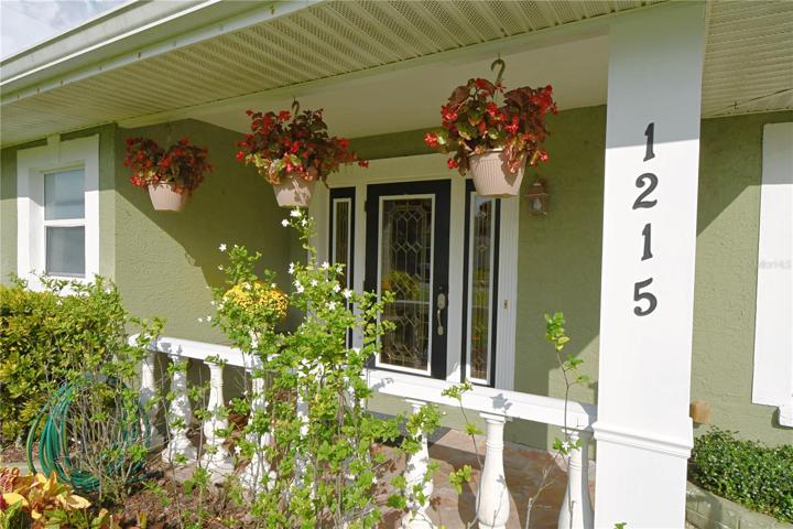 The front decorative door with sidelights adds a touch of charm and sets the tone for the elegance that awaits inside.