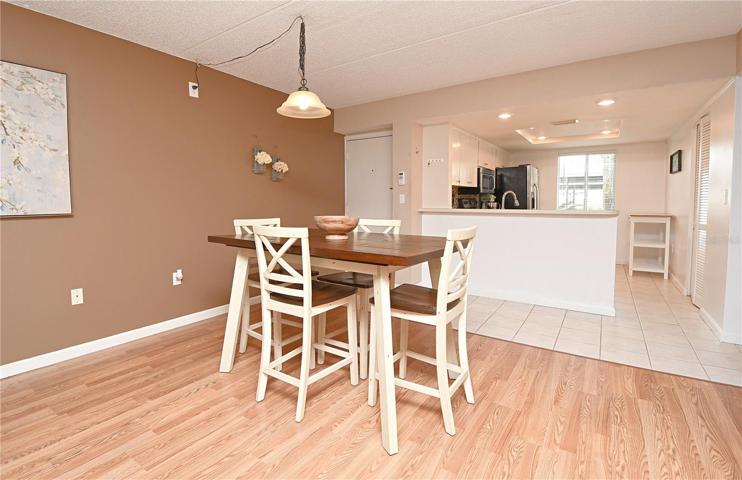 The laminate flooring in the dining room provides a low-maintenance option that is easy to clean and maintain, ensuring that your home always looks its best.