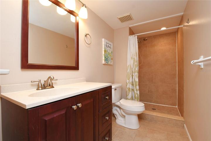 The en-suite bathroom boasts a luxurious walk-in shower, offering a spa-like experience right at home.